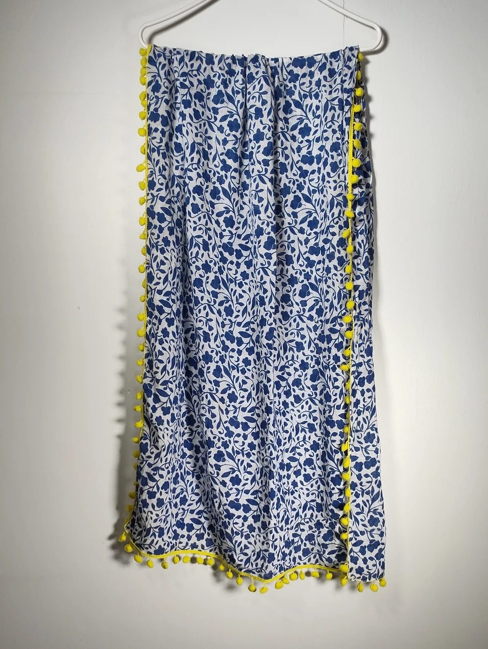 White and‎ blue floral pattern scarf with bright yellow pom pom trim